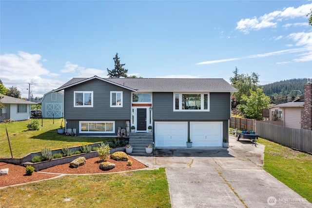 bi-level home featuring concrete driveway and an attached garage