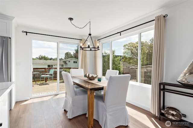 dining area featuring a chandelier and wood finished floors