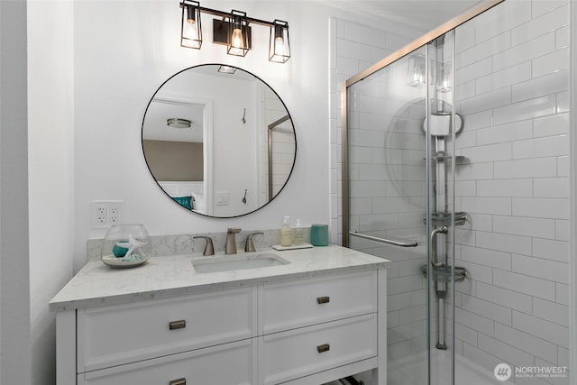 full bathroom featuring a stall shower and vanity