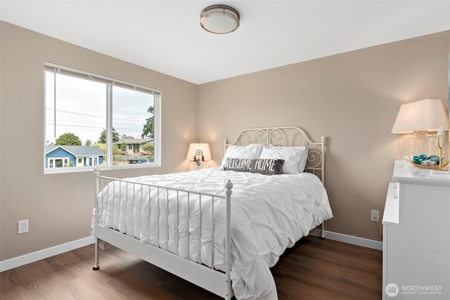 bedroom featuring wood finished floors and baseboards