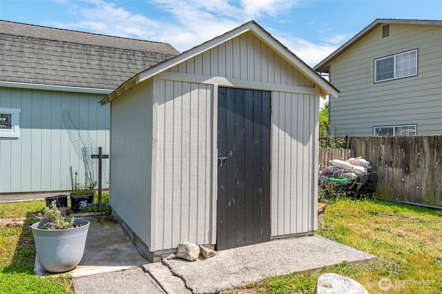 view of shed with fence