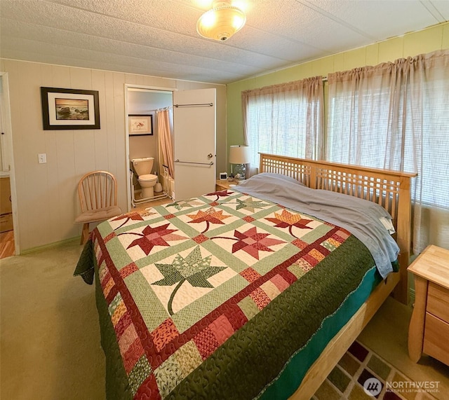 carpeted bedroom featuring connected bathroom