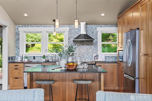 1533 S Sunset Dr, Tacoma, WA 98465 - kitchen with appliances with stainless steel finishes, wall chimney exhaust hood, dark countertops, tasteful backsplash, and recessed lighting