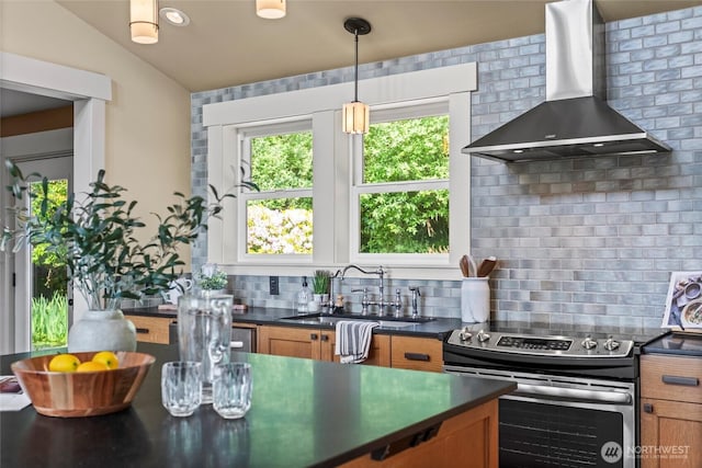 1533 S Sunset Dr, Tacoma, WA 98465 - kitchen with wall chimney range hood, stainless steel electric stove, brown cabinetry, dark countertops, and vaulted ceiling