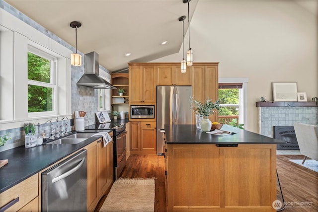 1533 S Sunset Dr, Tacoma, WA 98465 - kitchen featuring wall chimney exhaust hood, appliances with stainless steel finishes, wood finished floors, dark countertops, and vaulted ceiling