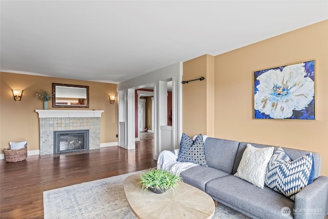 1533 S Sunset Dr, Tacoma, WA 98465 - living area with wood finished floors, a tiled fireplace, and baseboards