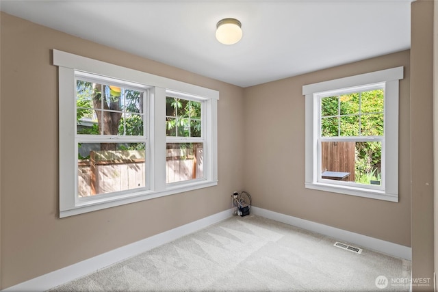 1533 S Sunset Dr, Tacoma, WA 98465 - carpeted spare room featuring baseboards and plenty of natural light