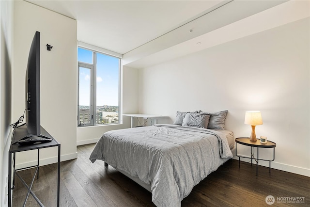 bedroom featuring baseboards and dark wood-style floors
