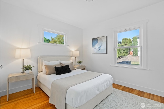 3112 13th Ave S, Seattle, WA 98144 - bedroom featuring baseboards, multiple windows, and wood finished floors