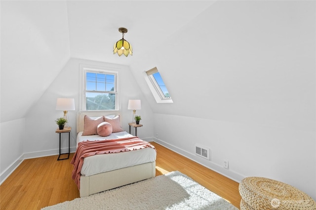 3112 13th Ave S, Seattle, WA 98144 - bedroom featuring lofted ceiling, a skylight, baseboards, and wood finished floors