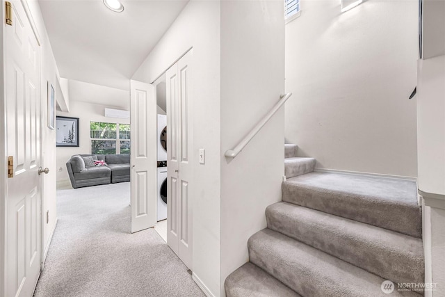 stairs featuring stacked washing machine and dryer, carpet flooring, and recessed lighting