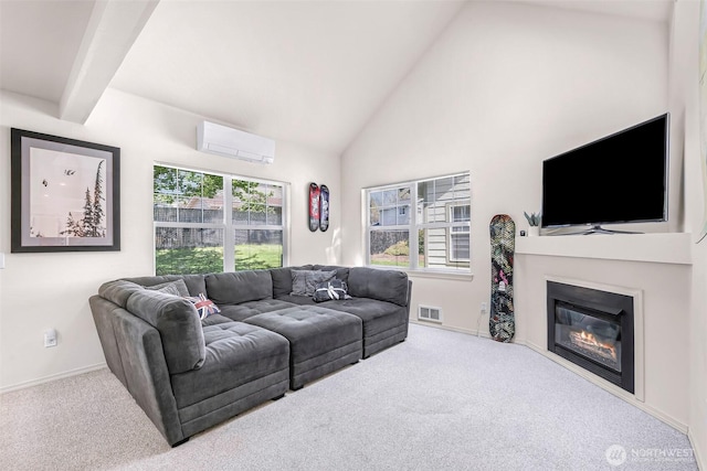 living area with an AC wall unit, carpet, a glass covered fireplace, high vaulted ceiling, and baseboards