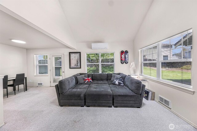 carpeted living area featuring a wall mounted AC, healthy amount of natural light, high vaulted ceiling, and baseboards
