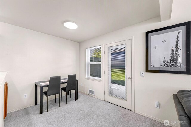 carpeted office space with baseboards
