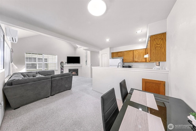 carpeted dining area with a wall mounted AC, lofted ceiling, a fireplace, and recessed lighting