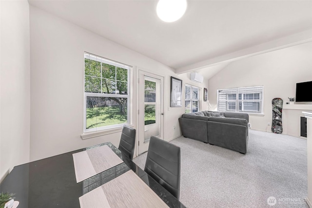 living area with vaulted ceiling, carpet flooring, and a wall unit AC