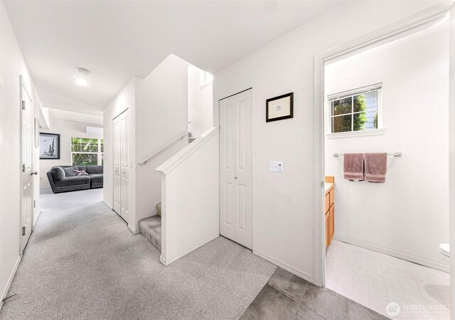 corridor with stairway and baseboards