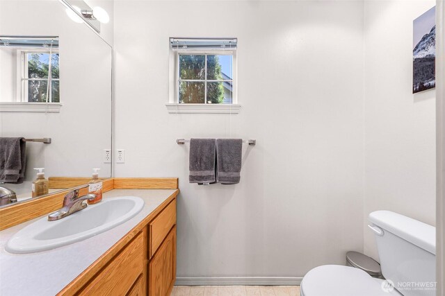 bathroom featuring toilet and vanity