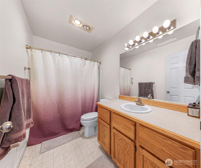 bathroom with vanity and toilet