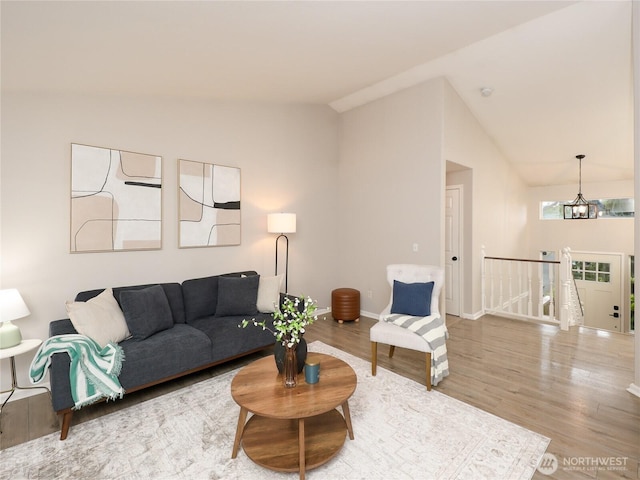 6723 50th Pl NE, Marysville, WA 98270 - living room featuring lofted ceiling, wood finished floors, and baseboards