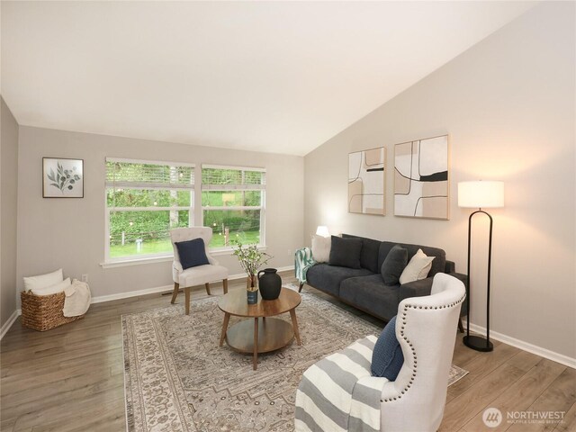 6723 50th Pl NE, Marysville, WA 98270 - living room featuring wood finished floors, vaulted ceiling, and baseboards