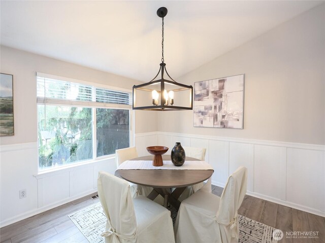6723 50th Pl NE, Marysville, WA 98270 - dining room with a chandelier, plenty of natural light, wood finished floors, a wainscoted wall, and a decorative wall