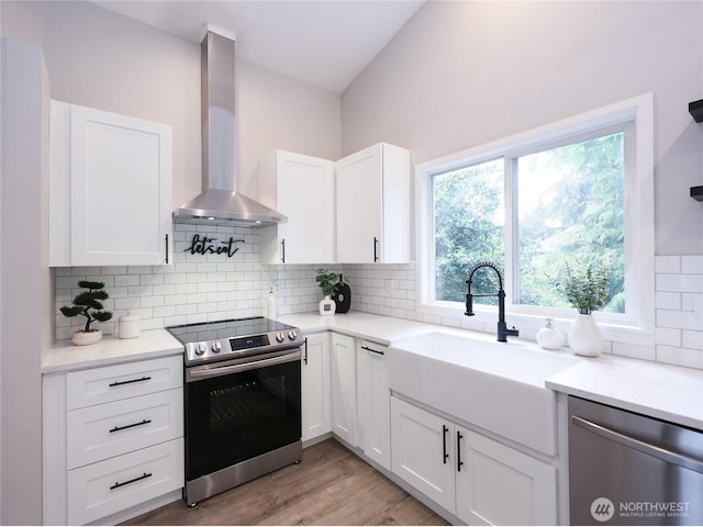 6723 50th Pl NE, Marysville, WA 98270 - kitchen with appliances with stainless steel finishes, wall chimney exhaust hood, decorative backsplash, and light countertops