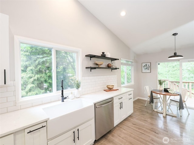 6723 50th Pl NE, Marysville, WA 98270 - kitchen featuring stainless steel dishwasher, backsplash, a sink, white cabinetry, and decorative light fixtures