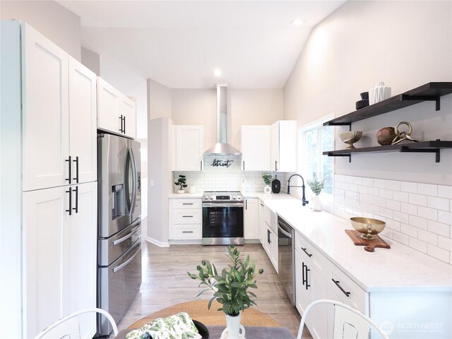 6723 50th Pl NE, Marysville, WA 98270 - kitchen featuring appliances with stainless steel finishes, wall chimney exhaust hood, backsplash, white cabinetry, and recessed lighting