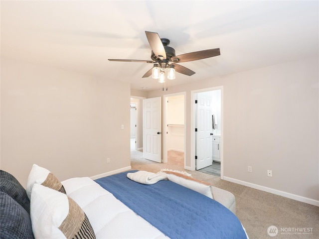 6723 50th Pl NE, Marysville, WA 98270 - bedroom featuring light carpet, baseboards, a walk in closet, and a ceiling fan