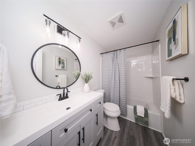 6723 50th Pl NE, Marysville, WA 98270 - bathroom featuring wood finished floors, toilet, vanity, and shower / bath combo with shower curtain