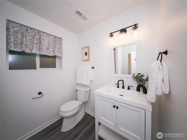 6723 50th Pl NE, Marysville, WA 98270 - bathroom with wood finished floors, backsplash, baseboards, toilet, and vanity