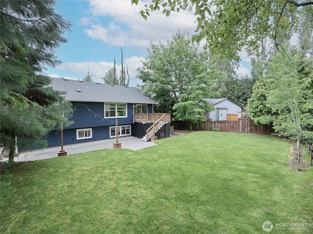 6723 50th Pl NE, Marysville, WA 98270 - back of property featuring stairway, a wooden deck, a patio area, and roof with shingles