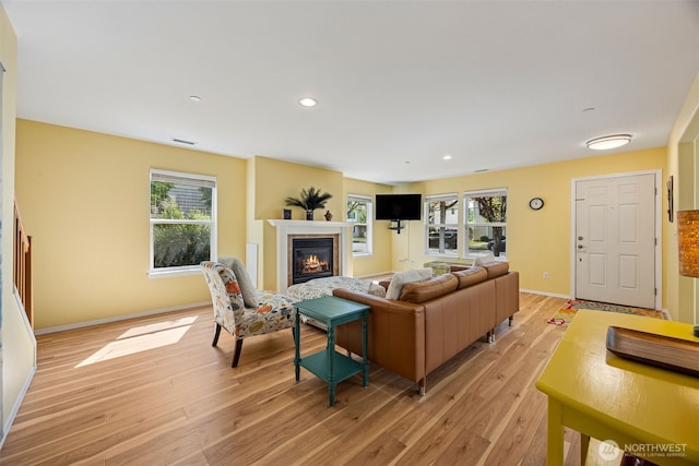 2758 Mcneil St, Dupont, WA 98327 - living room featuring a glass covered fireplace, light wood finished floors, baseboards, and recessed lighting