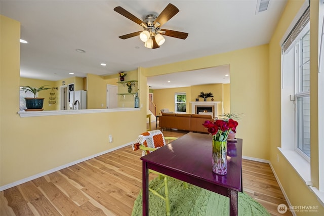 2758 Mcneil St, Dupont, WA 98327 - office featuring wood finished floors, baseboards, a warm lit fireplace, a ceiling fan, and recessed lighting