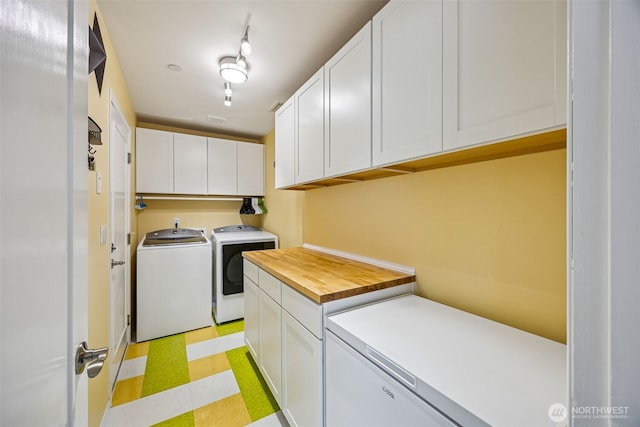 2758 Mcneil St, Dupont, WA 98327 - laundry room featuring washer and clothes dryer, cabinet space, and light floors