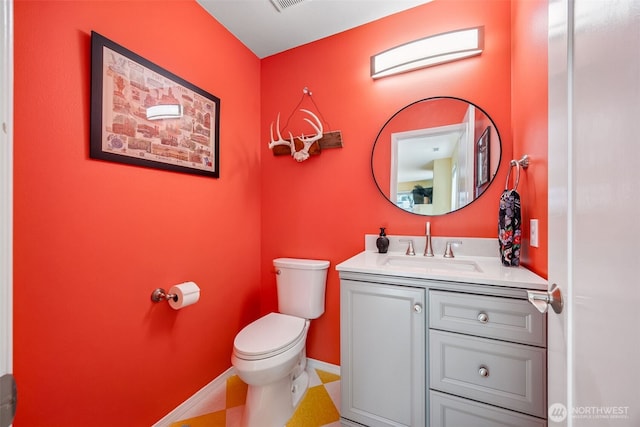 2758 Mcneil St, Dupont, WA 98327 - half bathroom featuring toilet, vanity, and baseboards
