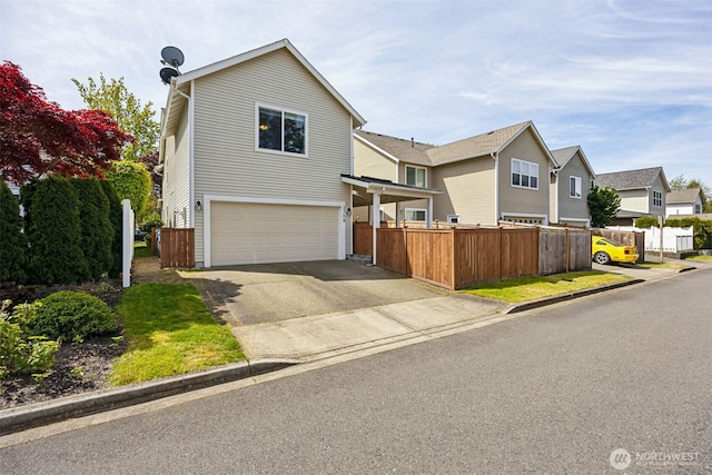 2758 Mcneil St, Dupont, WA 98327 - traditional home featuring an attached garage, driveway, and fence