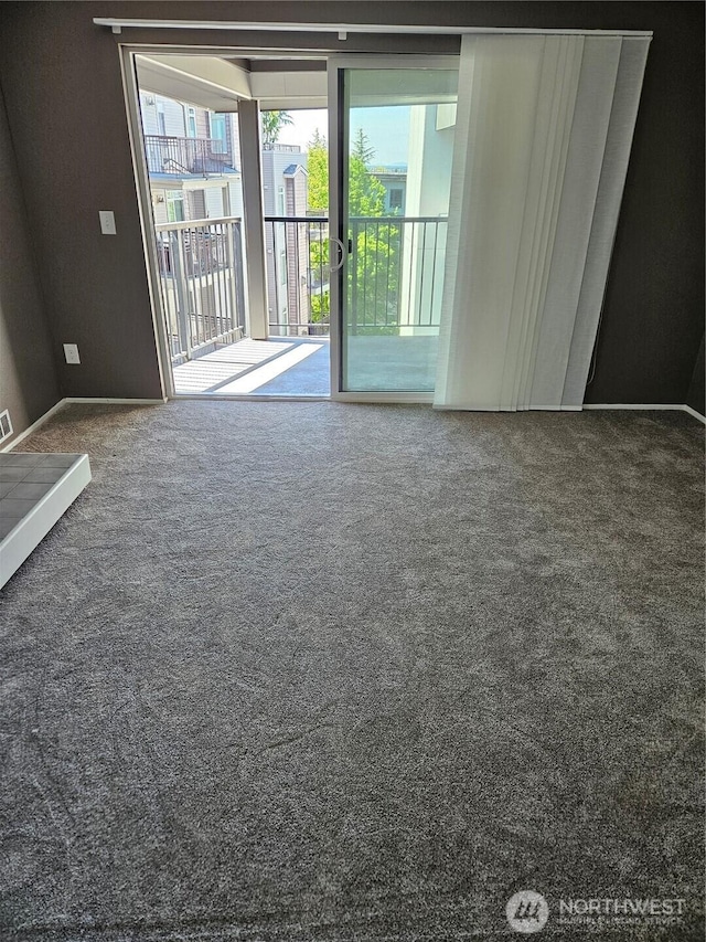 carpeted empty room with baseboards