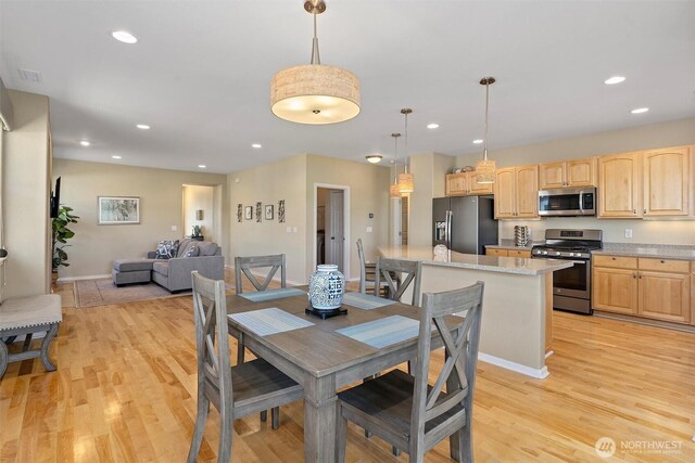 dining space featuring light wood-style flooring, recessed lighting, and baseboards