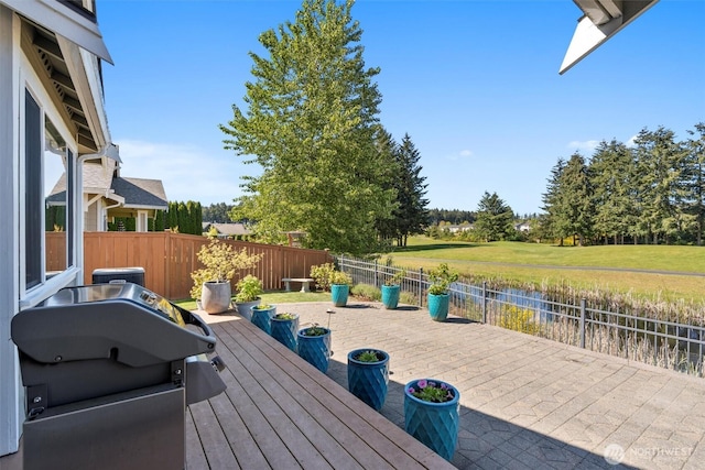 deck featuring a fenced backyard and a grill