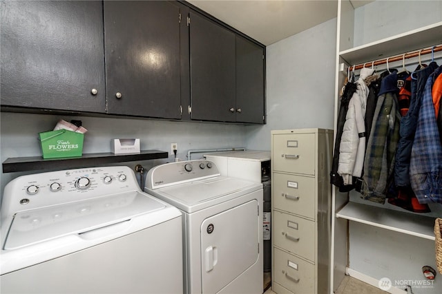 washroom with washing machine and dryer and cabinet space