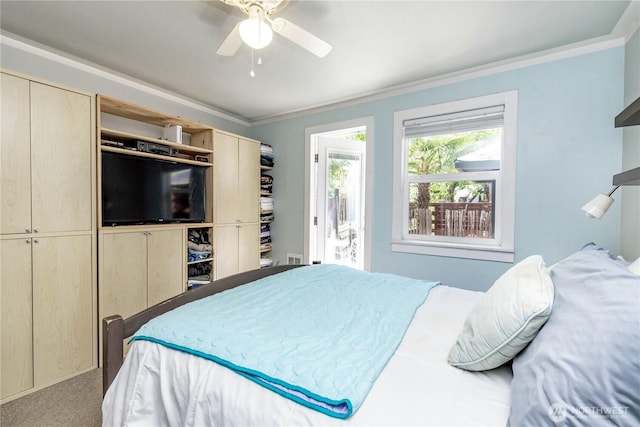 carpeted bedroom with crown molding and ceiling fan