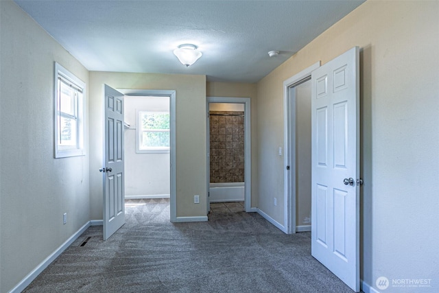 unfurnished bedroom with carpet and baseboards