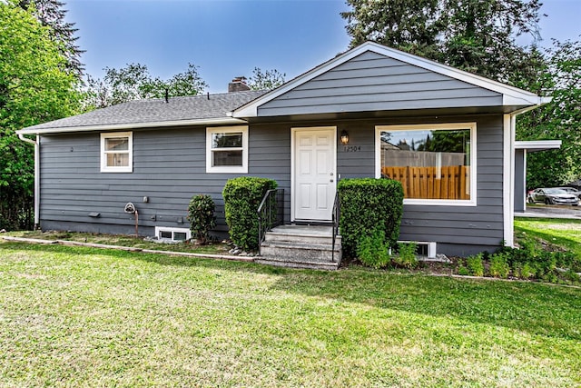 bungalow-style house with a front lawn and a chimney