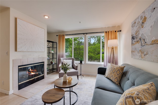18210 73rd Ave NE Unit 101, Kenmore, WA 98028 - living area with wood finished floors, a tile fireplace, and baseboards