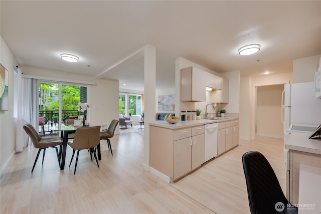 18210 73rd Ave NE Unit 101, Kenmore, WA 98028 - kitchen featuring a sink, white appliances, light countertops, light wood-style floors, and baseboards