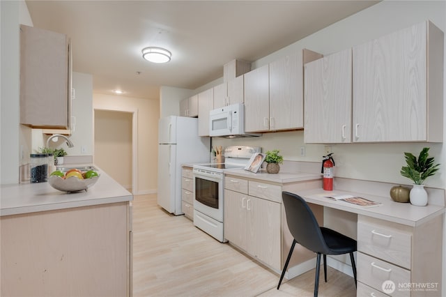 18210 73rd Ave NE Unit 101, Kenmore, WA 98028 - kitchen featuring white appliances, light wood finished floors, light countertops, and a sink