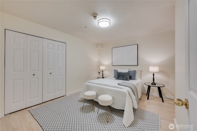 18210 73rd Ave NE Unit 101, Kenmore, WA 98028 - bedroom featuring light wood finished floors, a closet, and baseboards