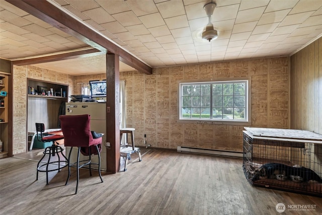 bar featuring baseboard heating, wood finished floors, built in features, beam ceiling, and wooden walls